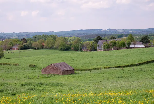 Tilted building and rolling hills along the RAVeL5 L38 in Thimister-Clermont, Belgium